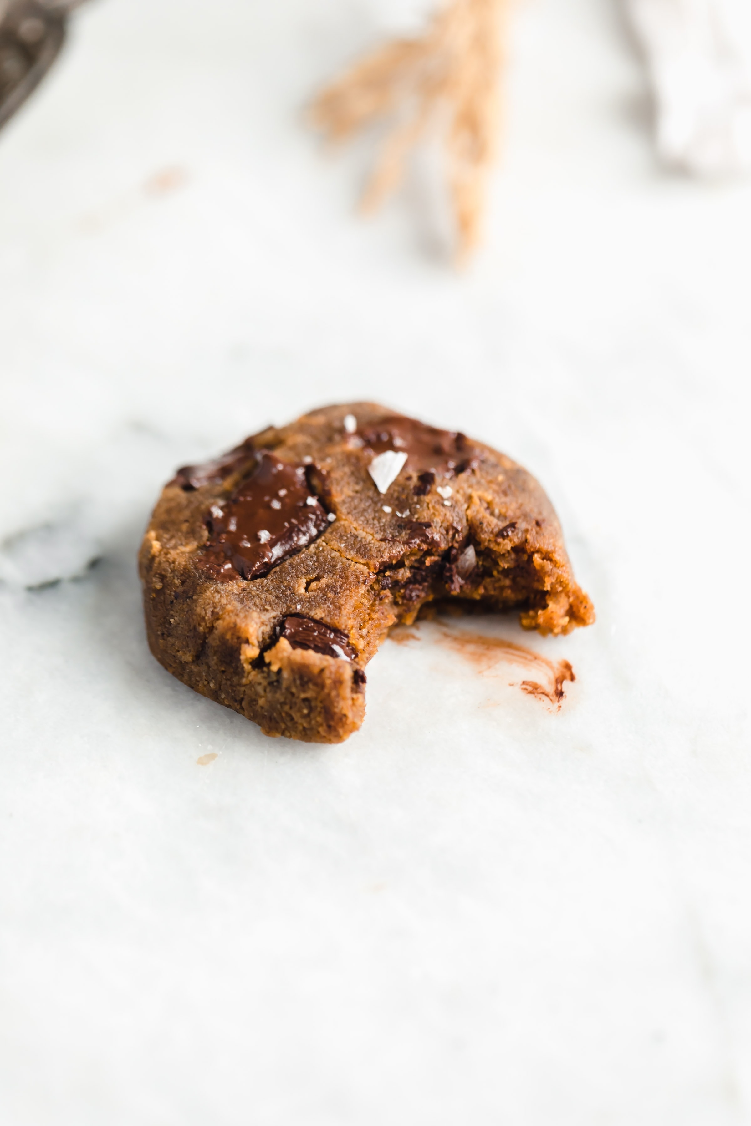 paleo pumpkin chocolate chip cookie with a bite taken out of it