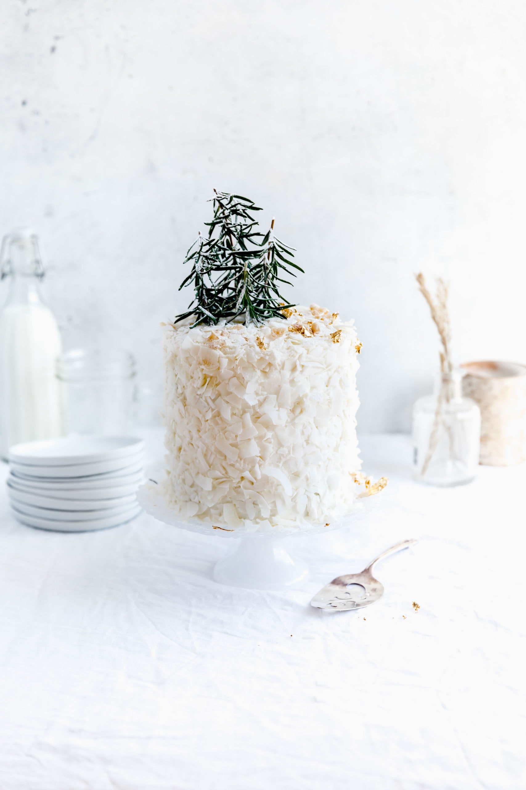 straight on shot of coconut layer cake on a cake stand