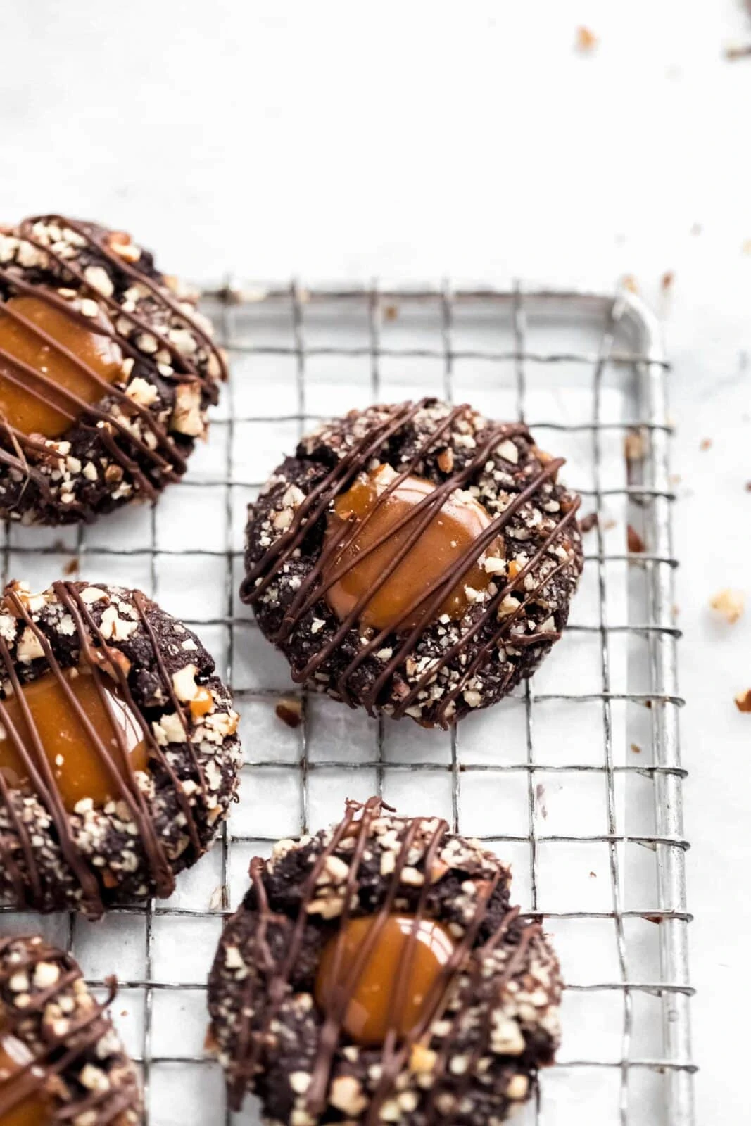 These turtle thumbprint cookies complete with a gooey caramel center and pecan coating. Try not to eat five?