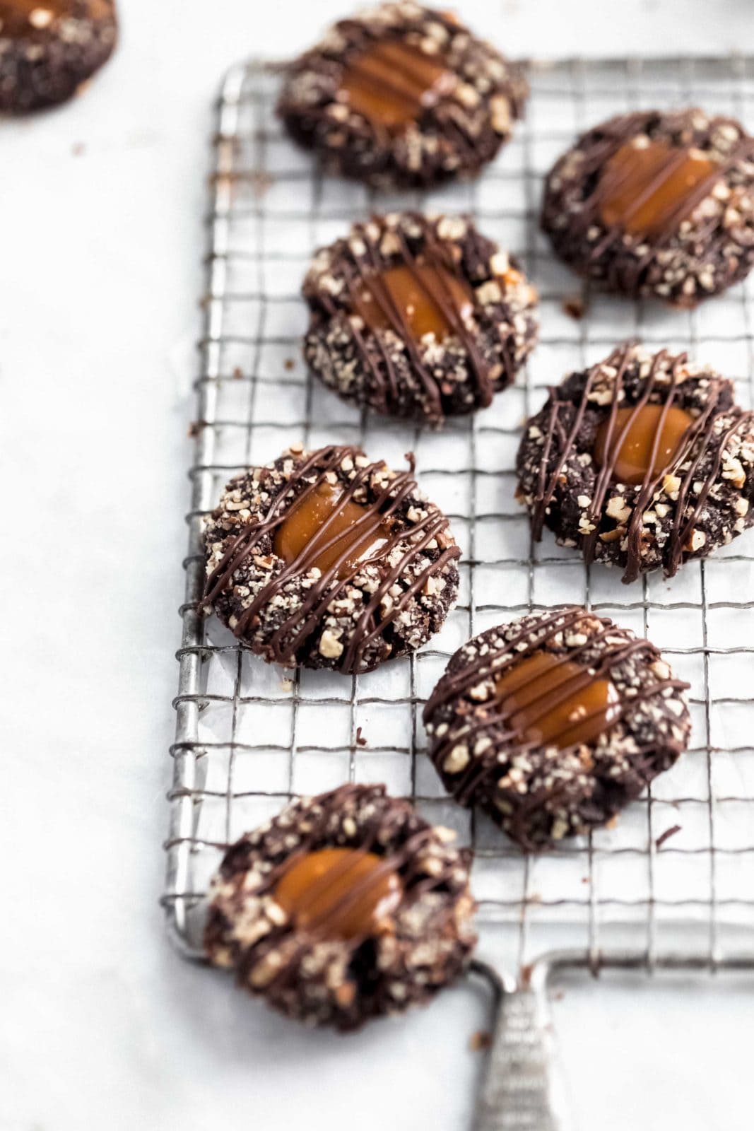 These turtle thumbprint cookies complete with a gooey caramel center and pecan coating. Try not to eat five?