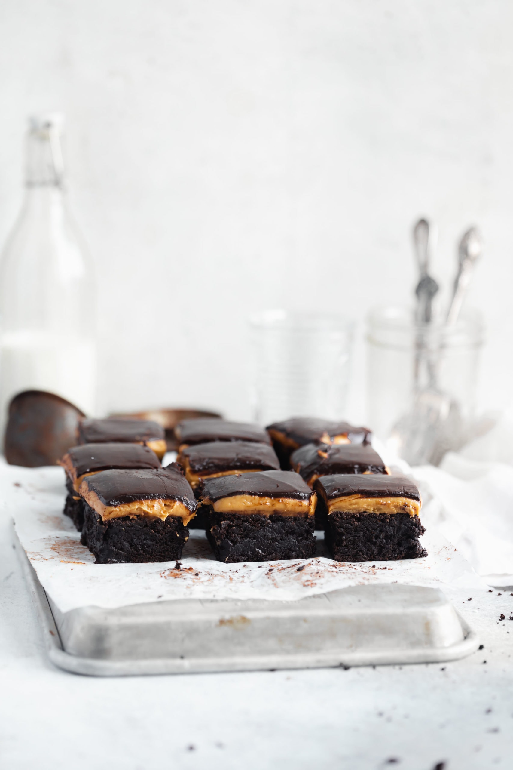 straight on shot of peanut butter chocolate brownies topped with a thick ganache