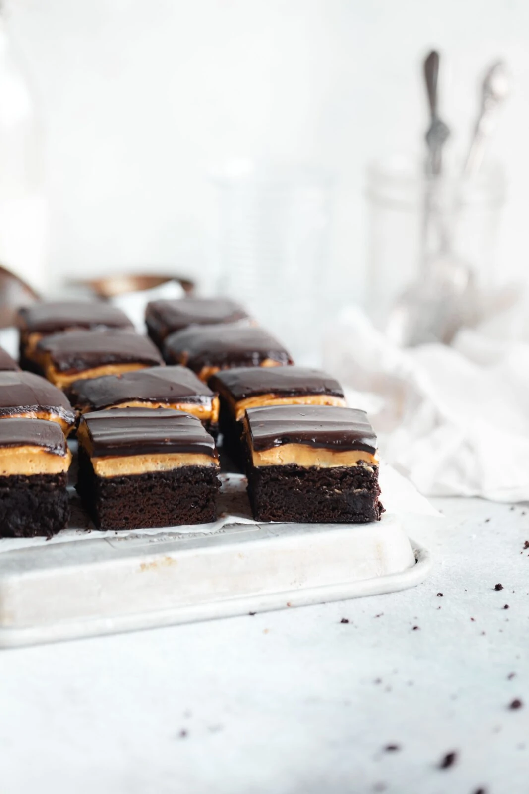 fudgy brownies topped with a thick layer of peanut butter and chocolate ganache