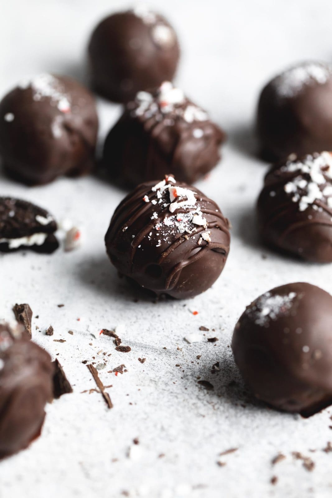 peppermint oreo truffles coated in chocolate and sprinkles with peppermint candies