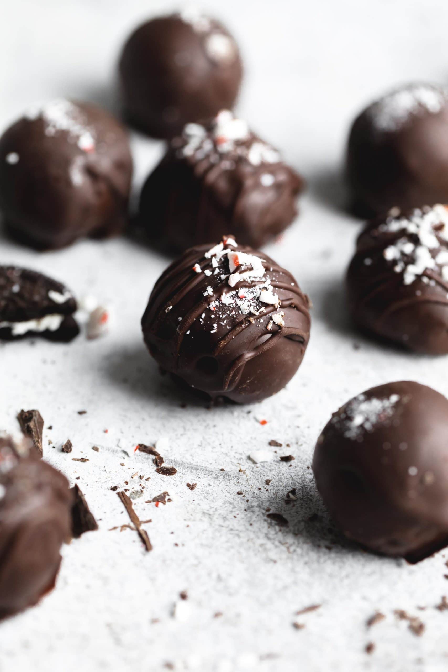 peppermint oreo truffles coated in chocolate and sprinkles with peppermint candies