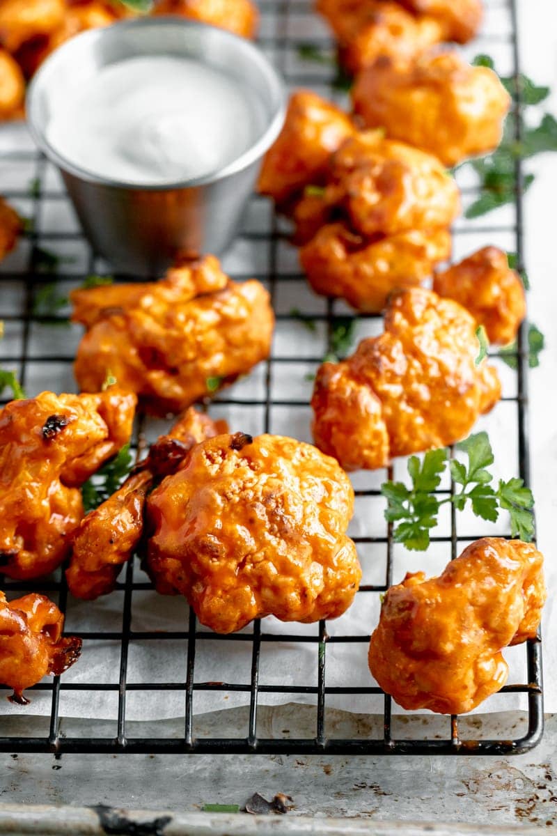 Whip up this easy buffalo cauliflower wings recipes for game day or a fun appetizer! Made with a crunchy buttermilk coating and a finger licking good buffalo coating, these vegan buffalo cauliflower wings are to die for!