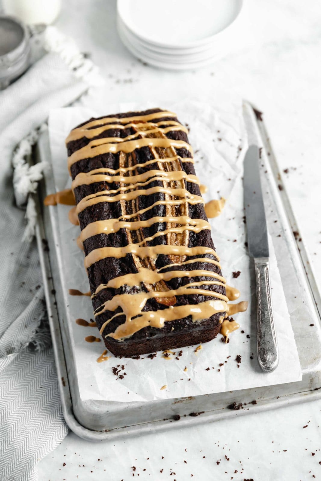moist and fudgy chocolate banana bread quick loaf on parchment paper