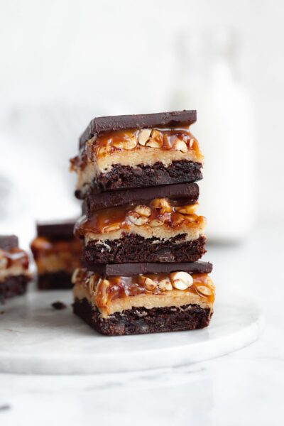stack of snickers brownies with gooey caramel
