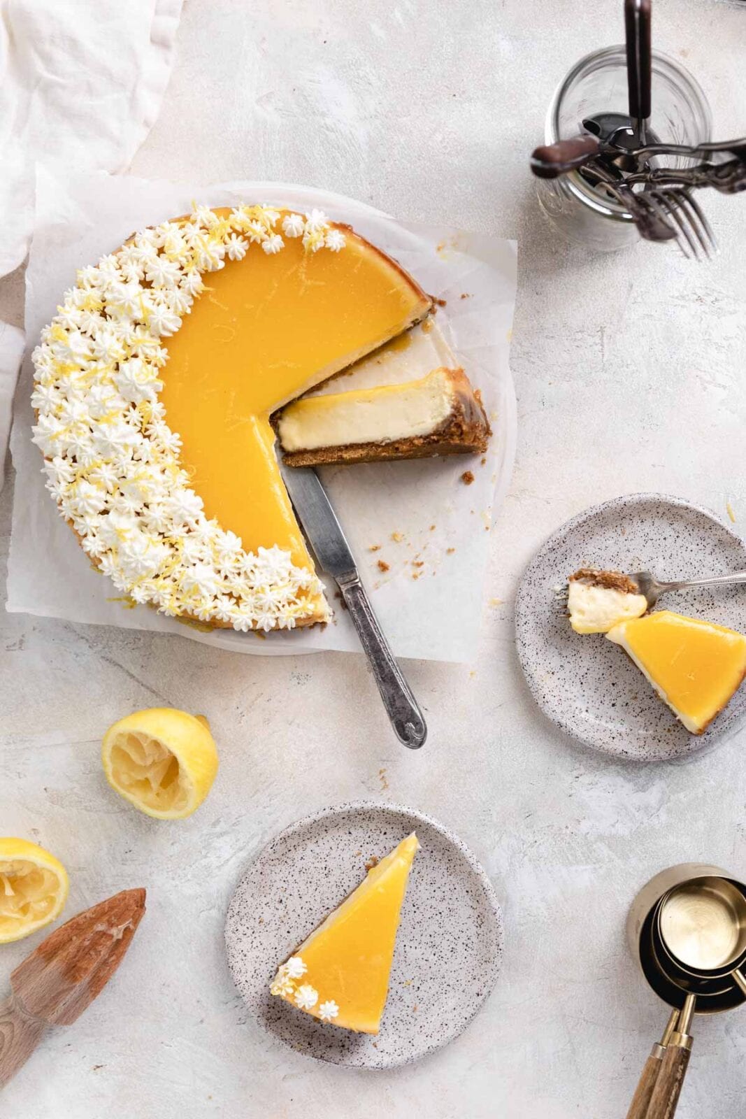 whole lemon cheesecake with plated slices