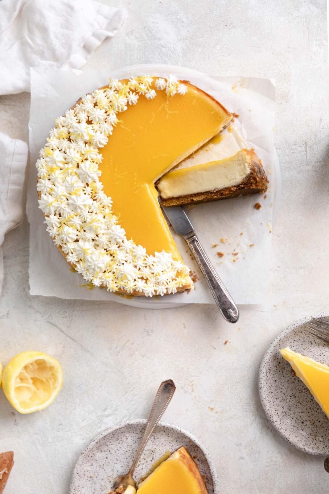 dreamy lemon curd cheesecake with slices cut out
