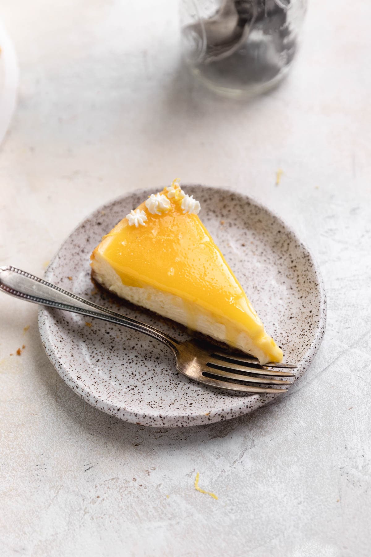 slice of lemon cheesecake topped with lemon curd