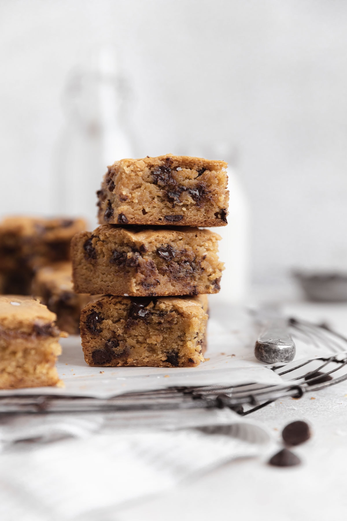 stack of chewy chocolate chip blondies on a cooling rack