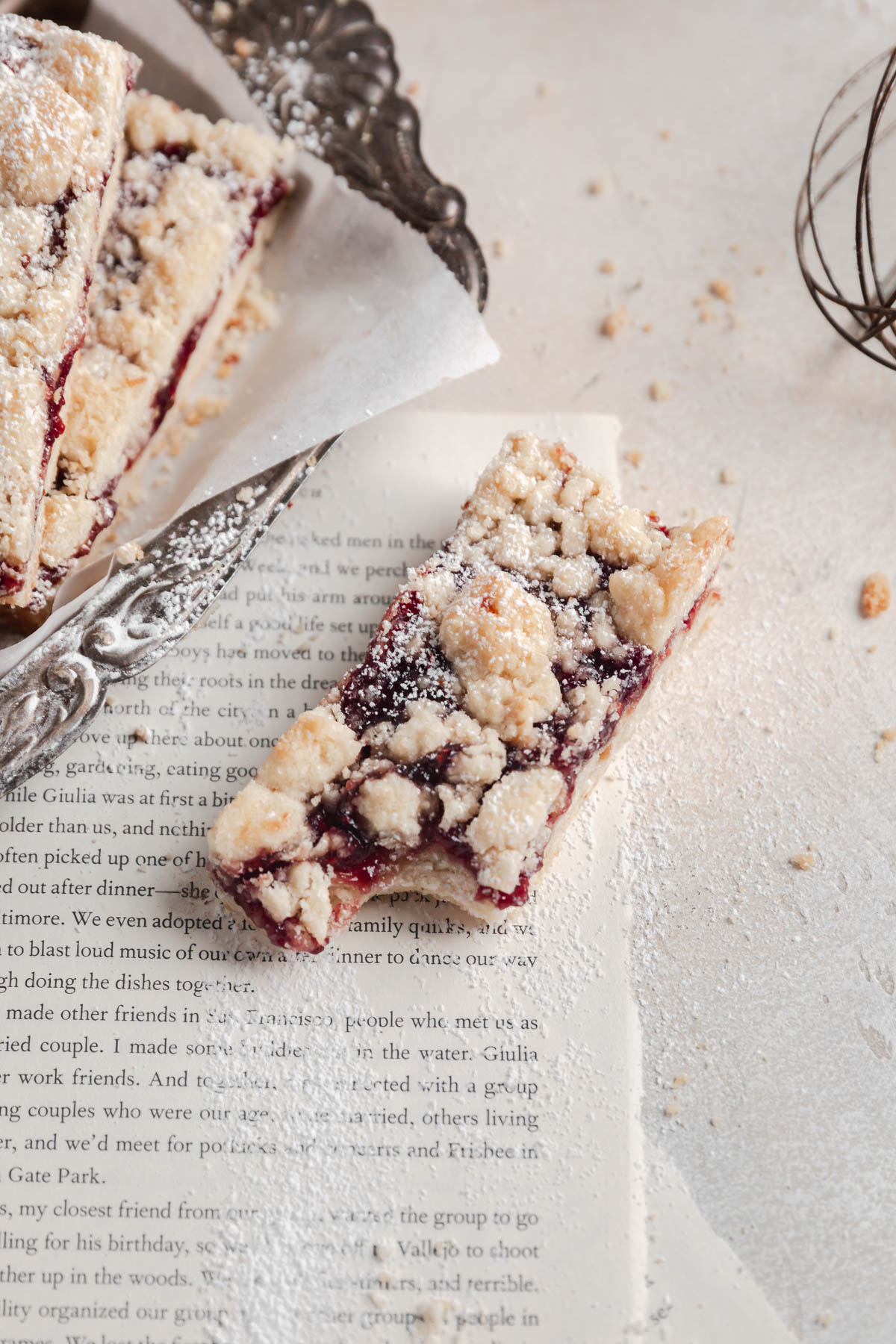 raspberry crumble bar dusted with powdered sugar