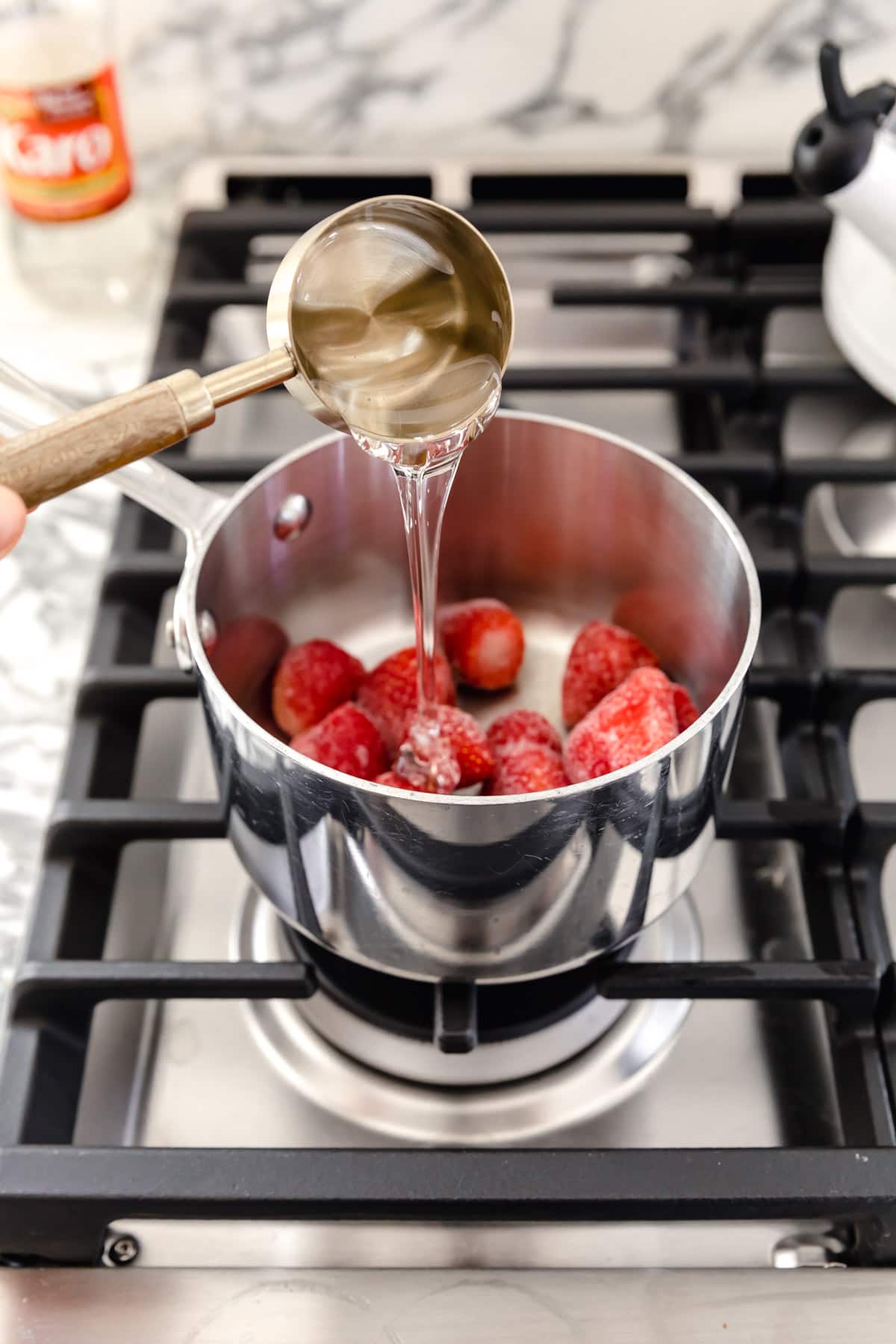corn syrup and strawberries in a pot