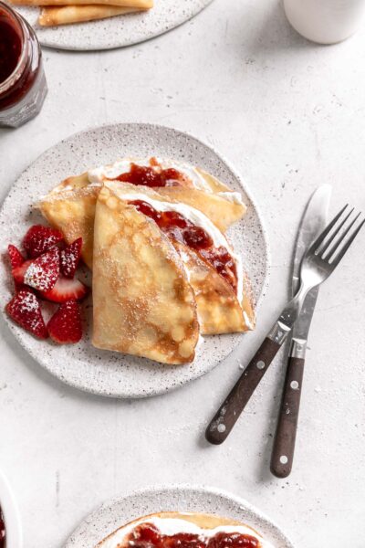 strawberry crepes with whipped cream and strawberry jam