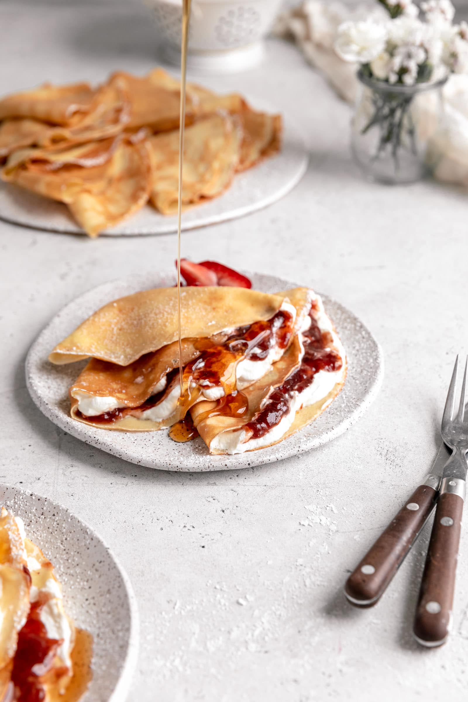 strawberry crepes drizzled with maple syrup