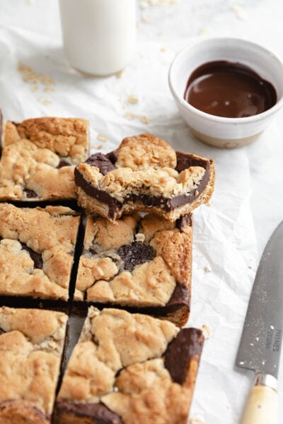 chocolate oatmeal fudge cookie bars with a thick fudge filling