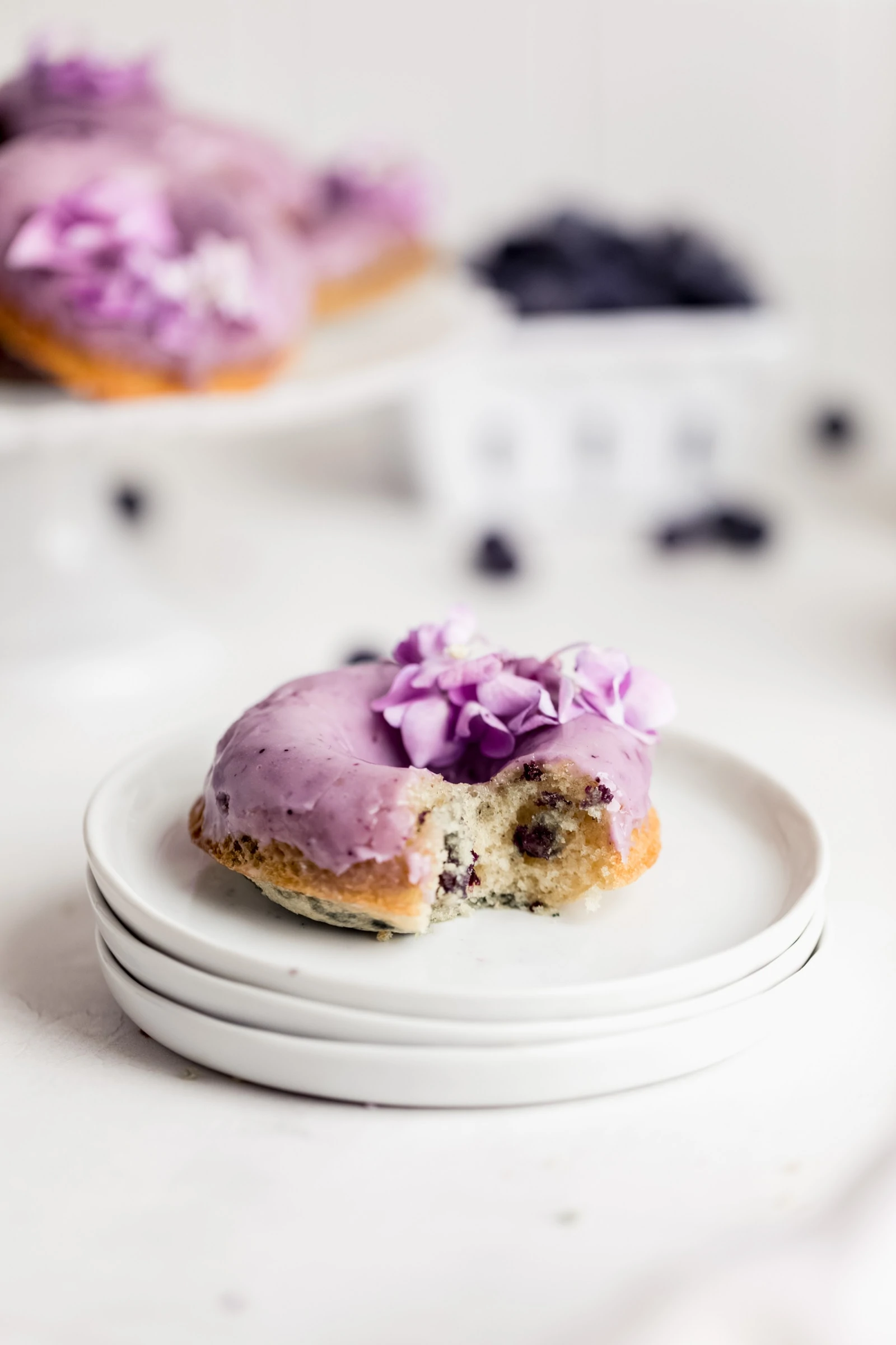 baked blueberry donuts with blueberry glaze on a plate