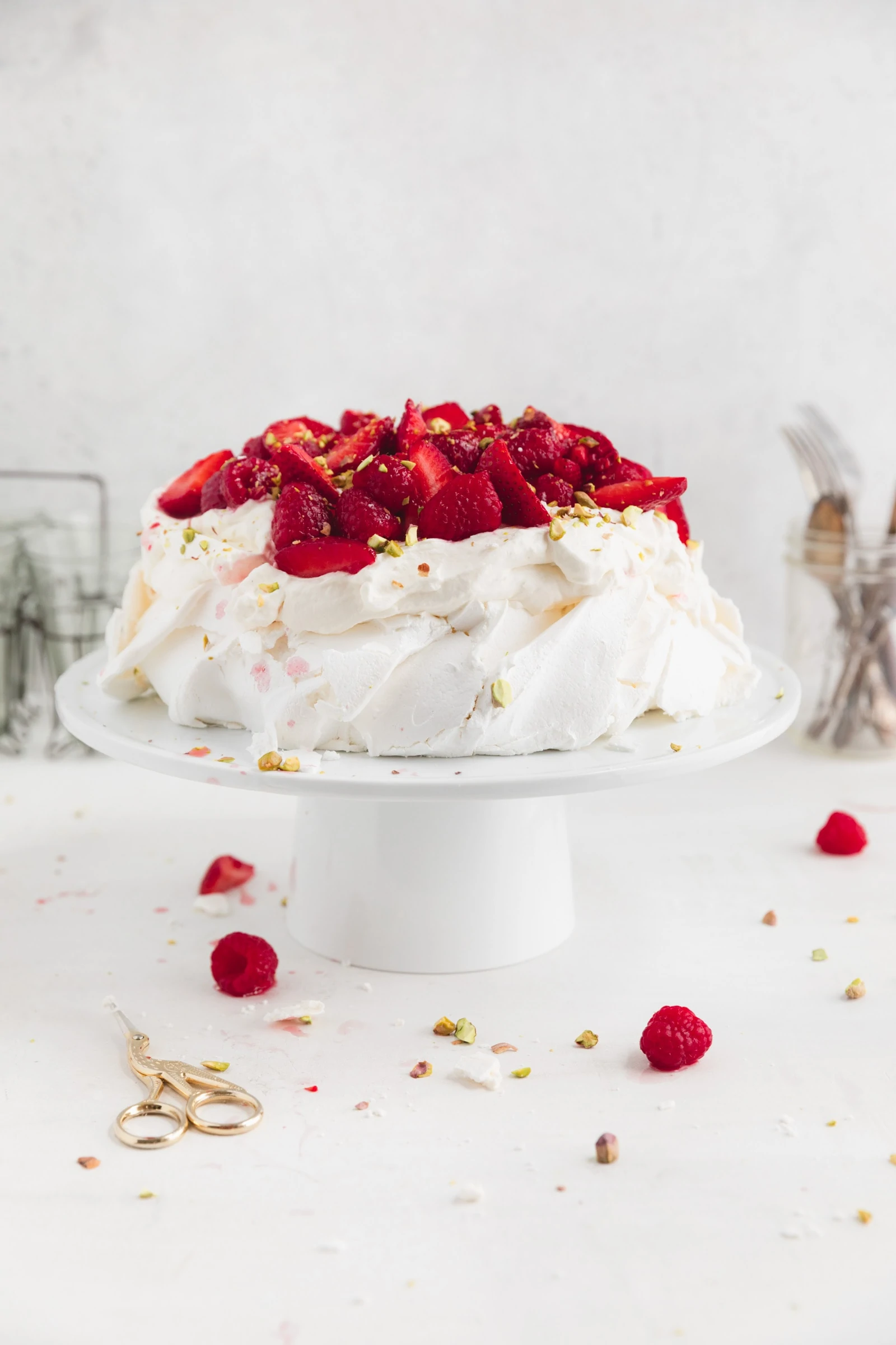 easy pavlova with berries on a cake stand
