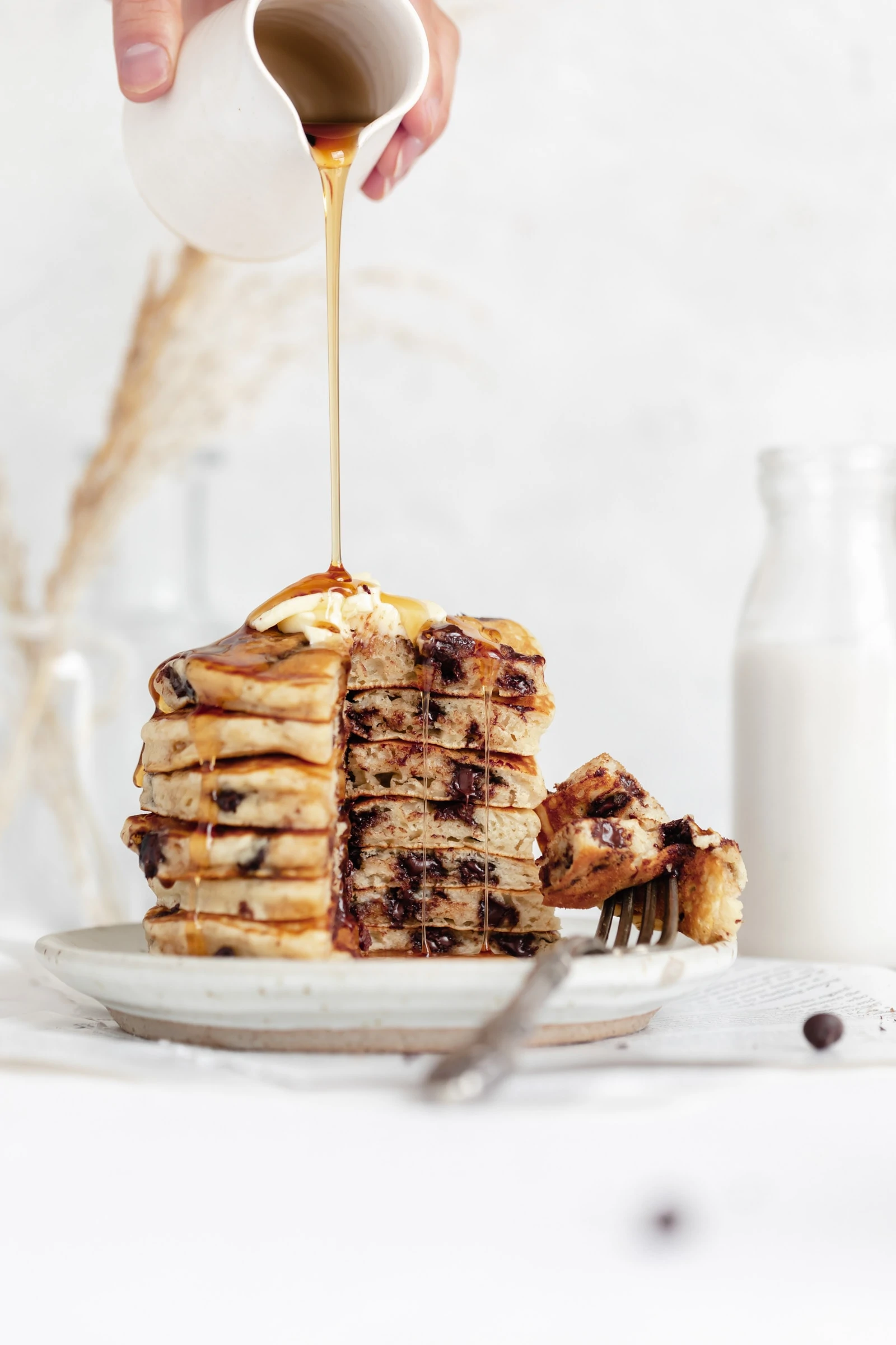 easy chocolate chip pancakes in a stack with maple syrup and butter