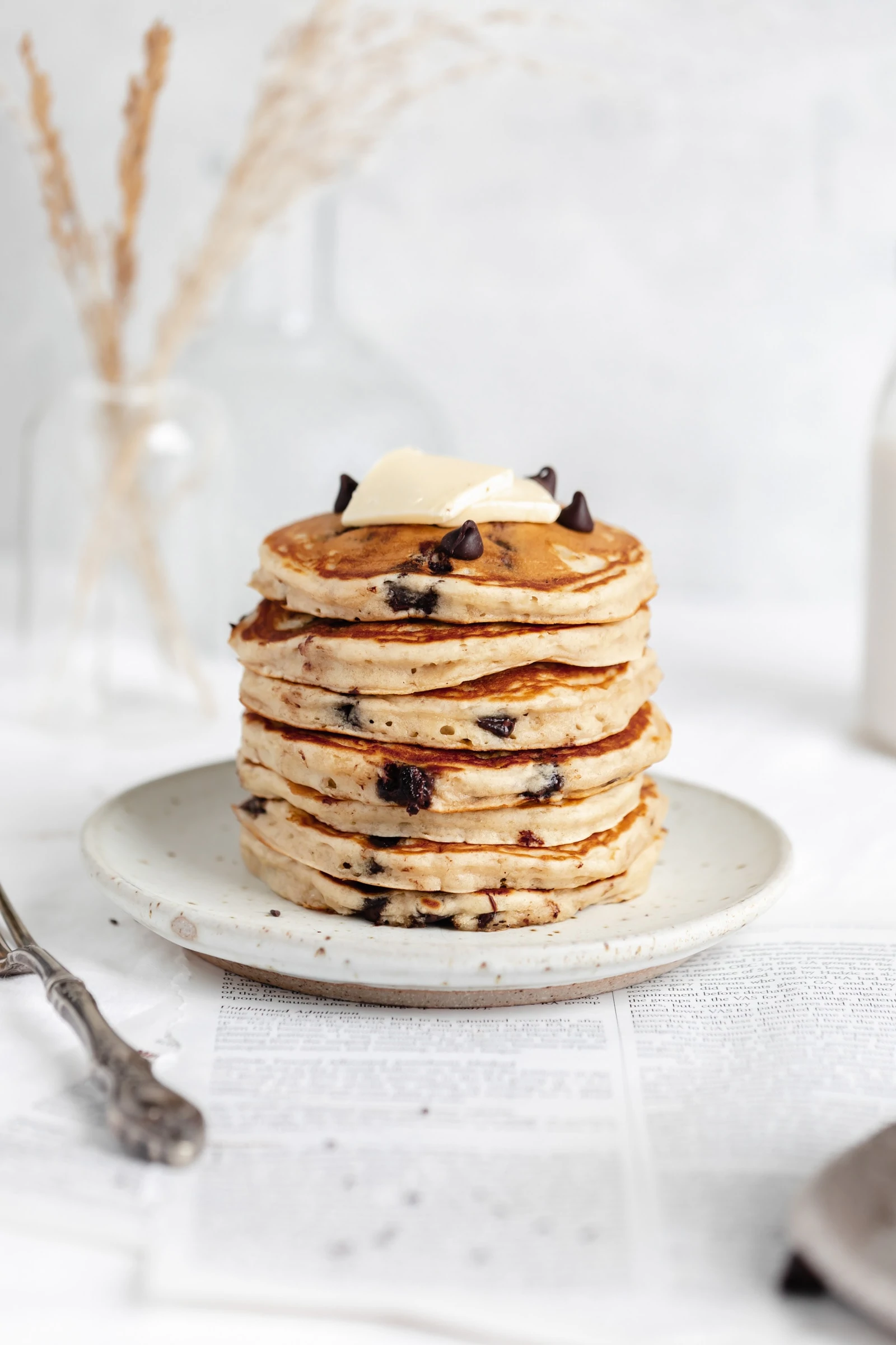 stack of fluffy chocolate chip pancakes with butter