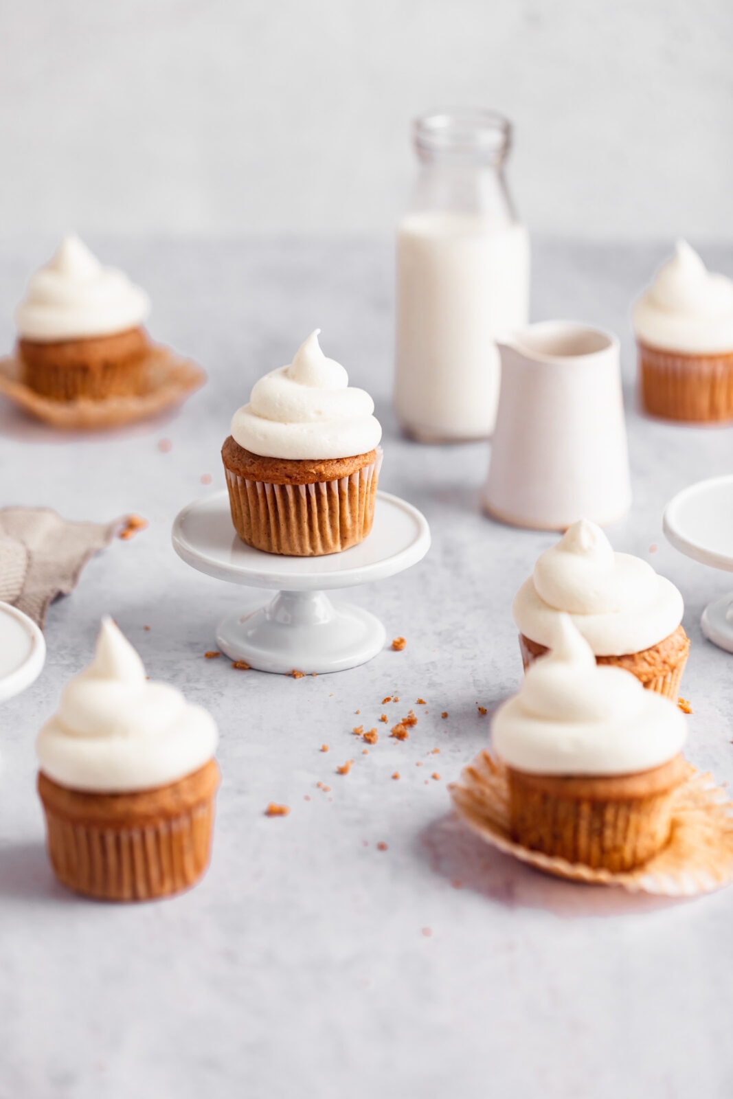 carrot cake cupcakes with cream cheese frosting on a cake stand