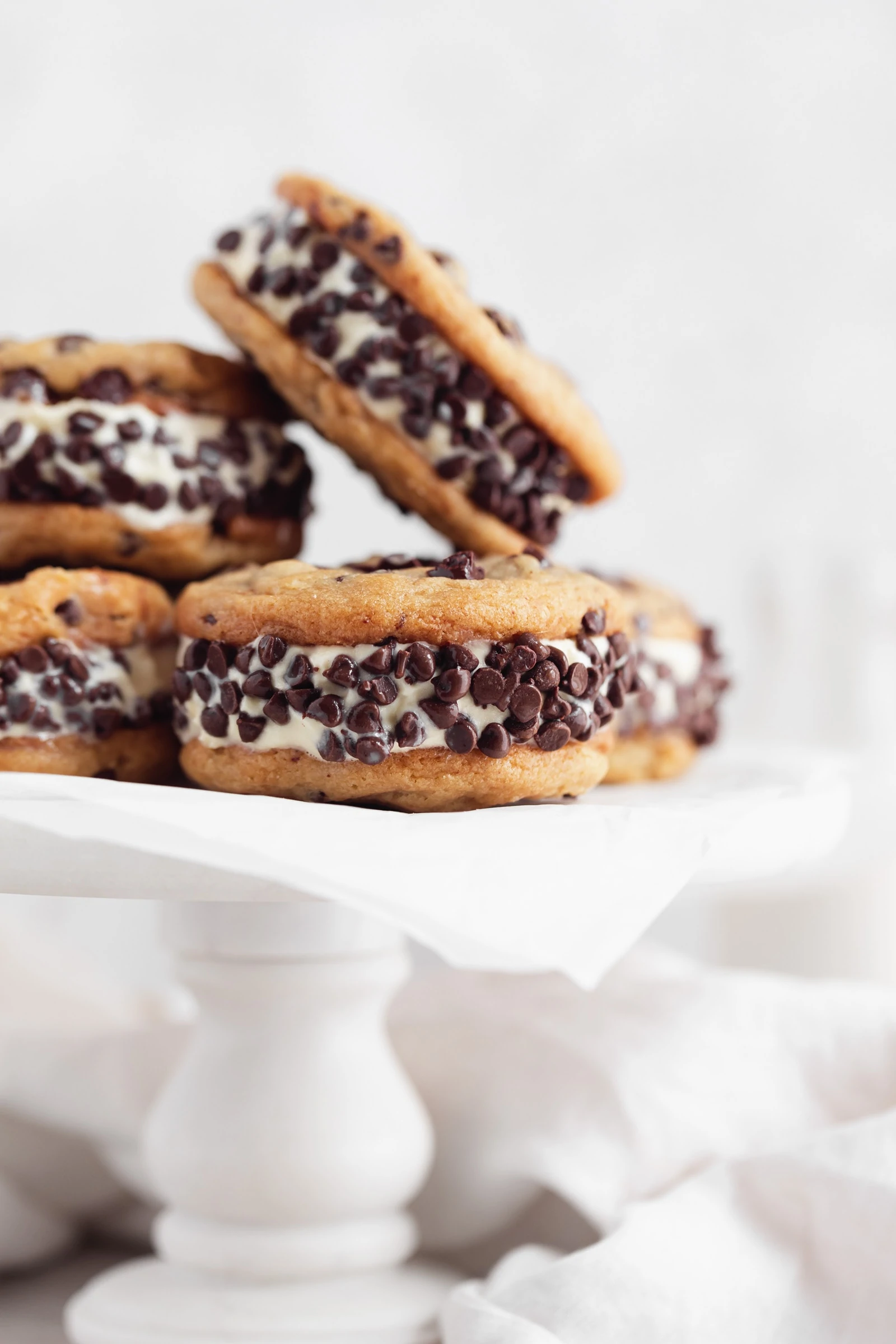 ice cream cookie sandwiches on a cake stand
