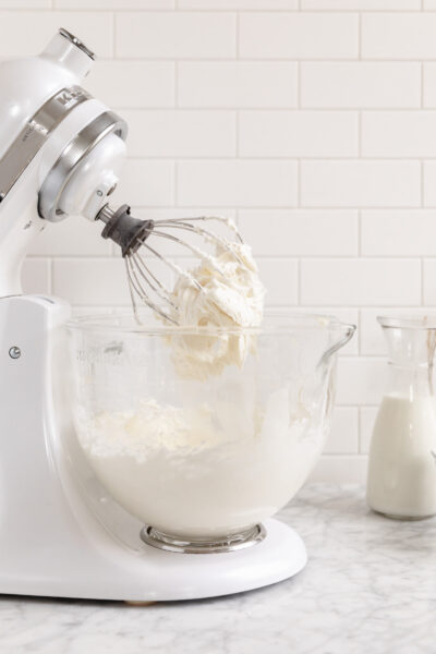 cream cheese frosting in a kitchen aid mixer with the whisk