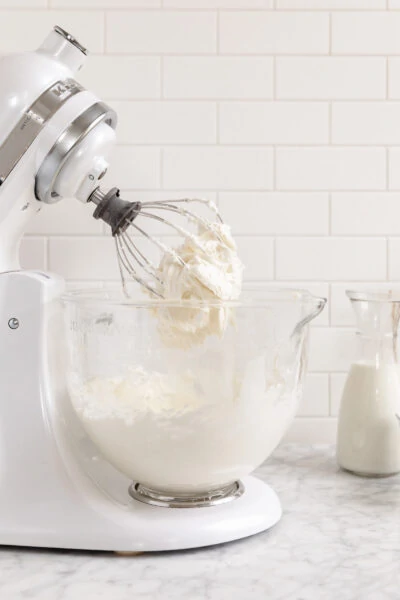 cream cheese frosting in a kitchen aid mixer with the whisk