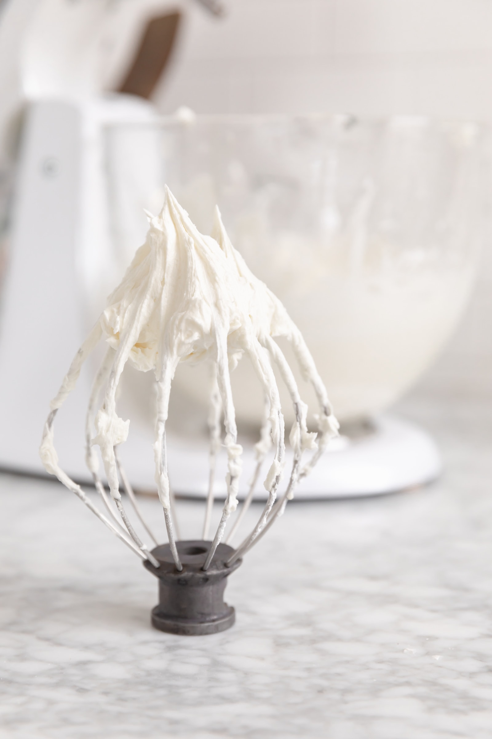 cream cheese frosting on a whisk