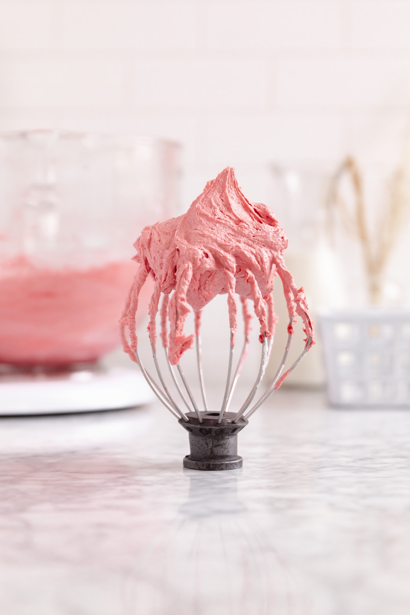 strawberry frosting on a whisk
