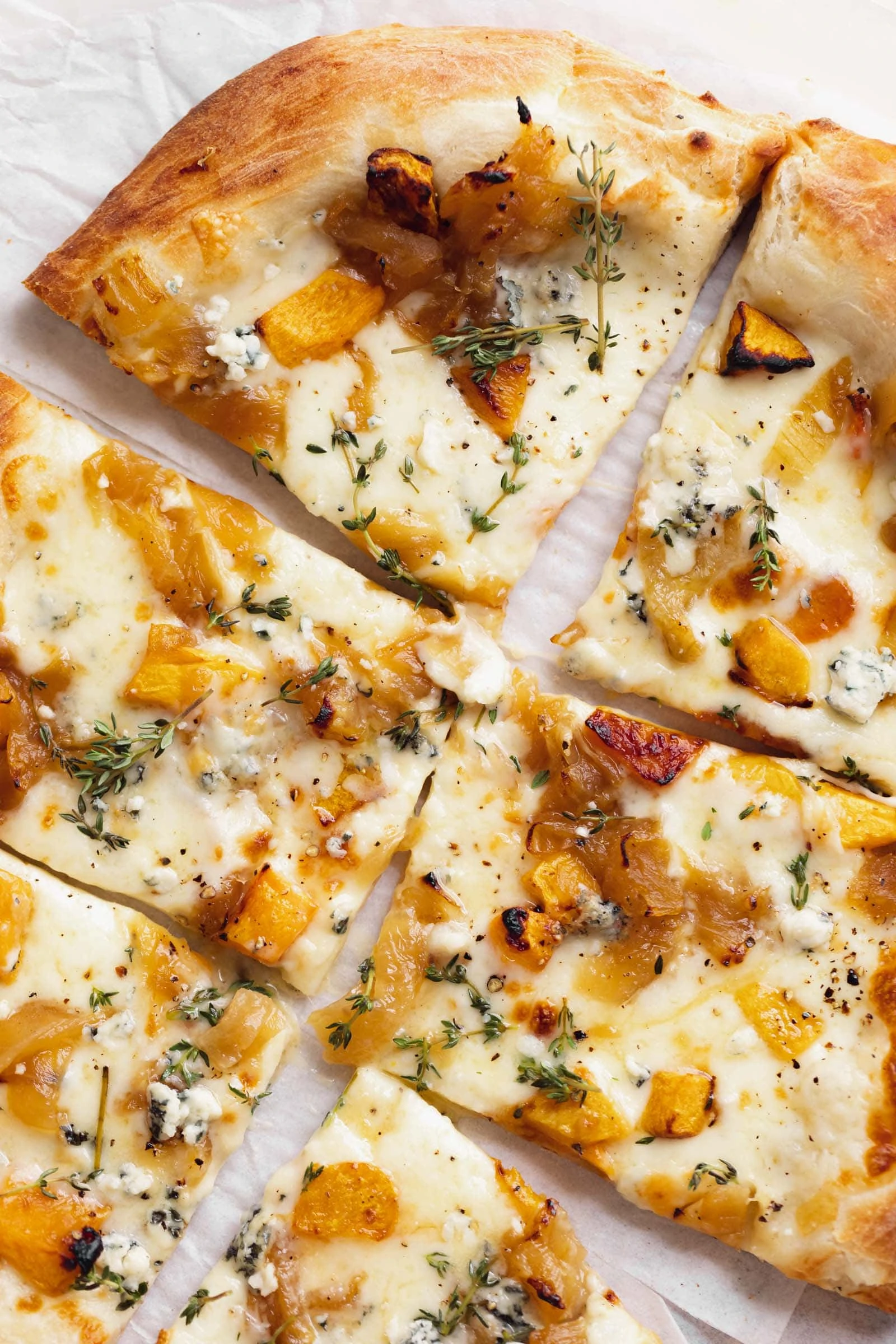 close up harvest pizza with squash, blue cheese and caramelized onions
