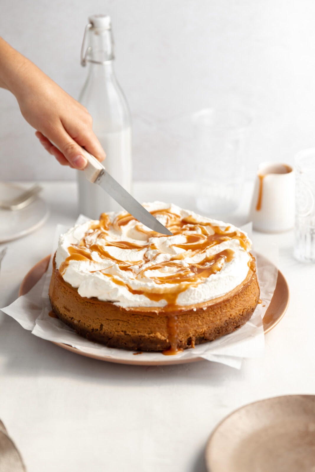 pumpkin cheesecake with whipped cream and caramel
