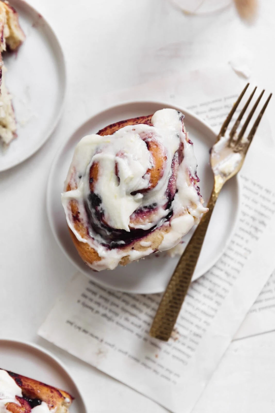 easy blueberry cinnamon rolls with cream cheese frosting on a plate