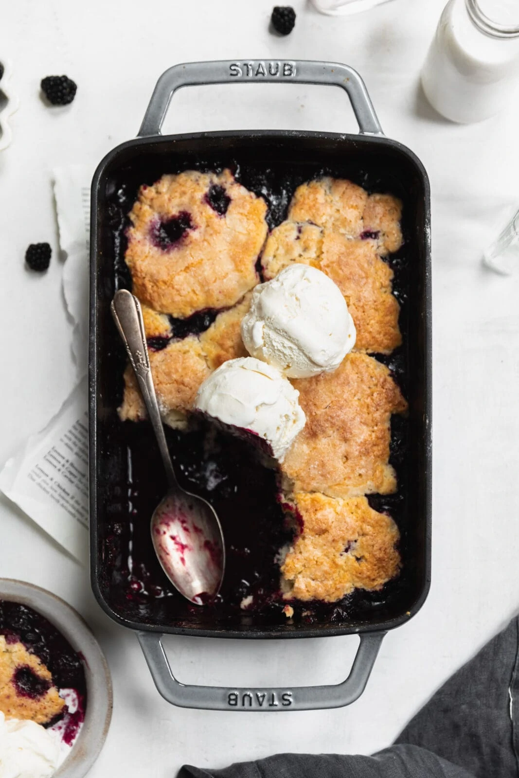 mixed berry cobbler with vanilla ice cream and spoon