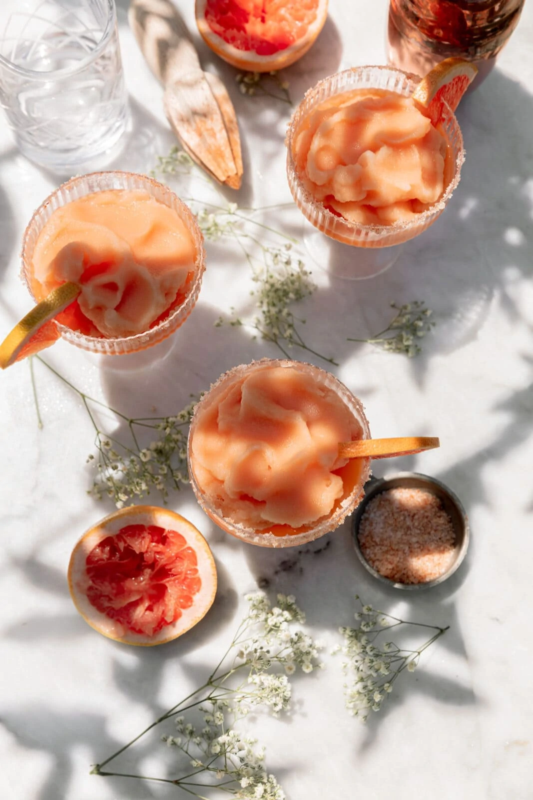 frozen palomas in glasses on a marble counter