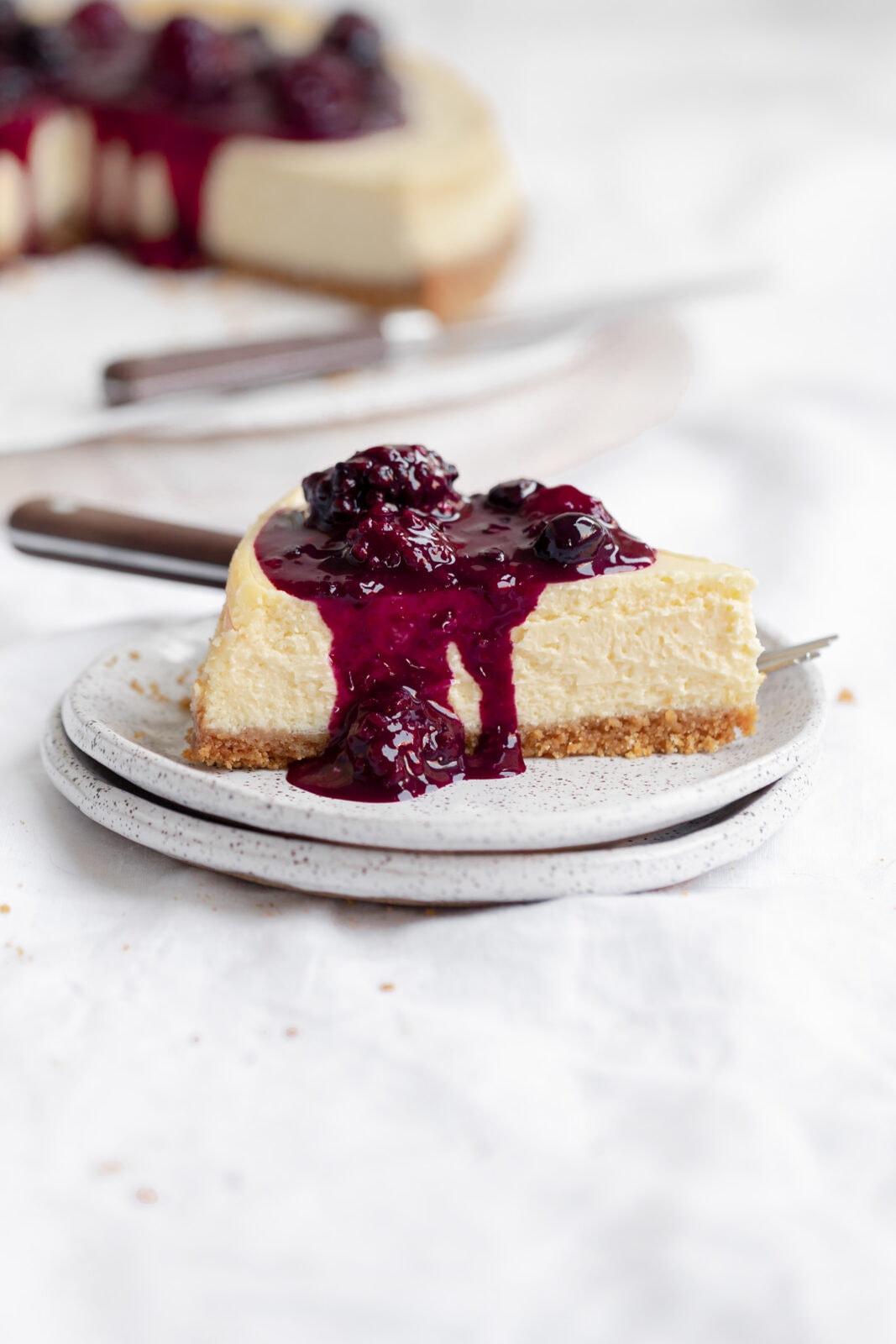 slice of cheesecake with berry compote