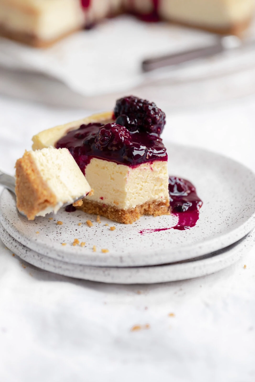 slice of cheesecake with berry compote on a plate