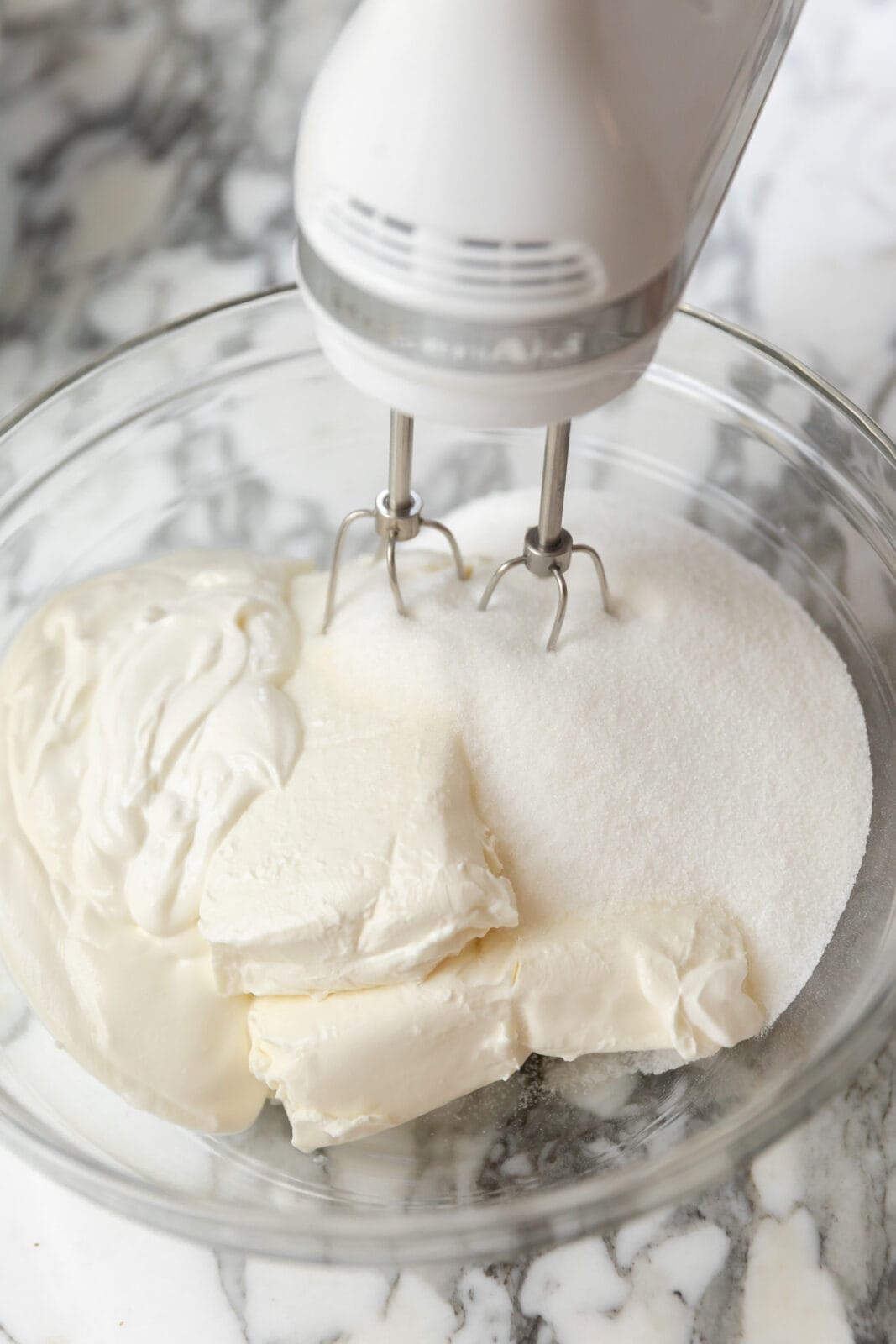 cream cheese and sugar mixing together