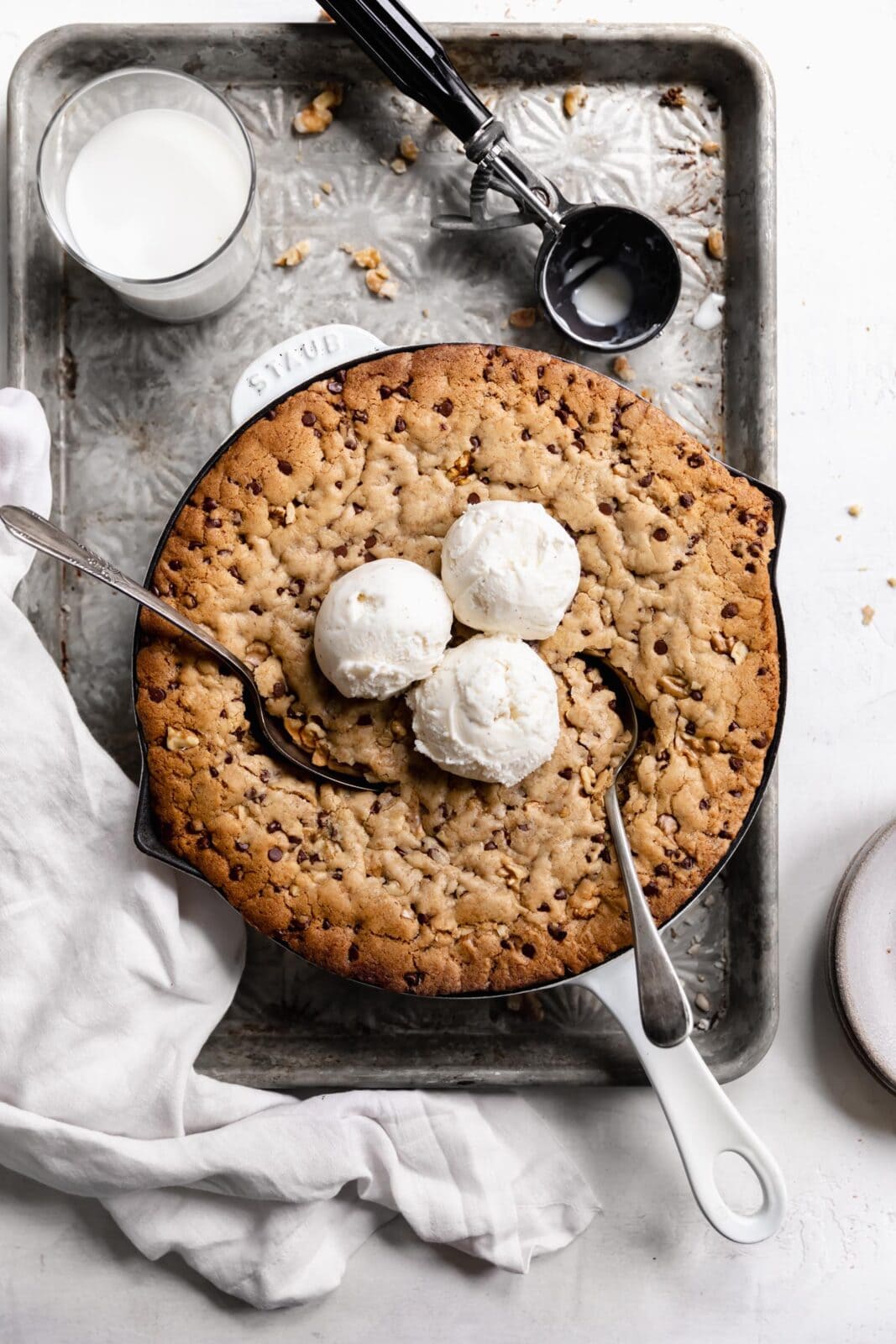 chocolate chip cookie in a skillet with scoops of ice cream