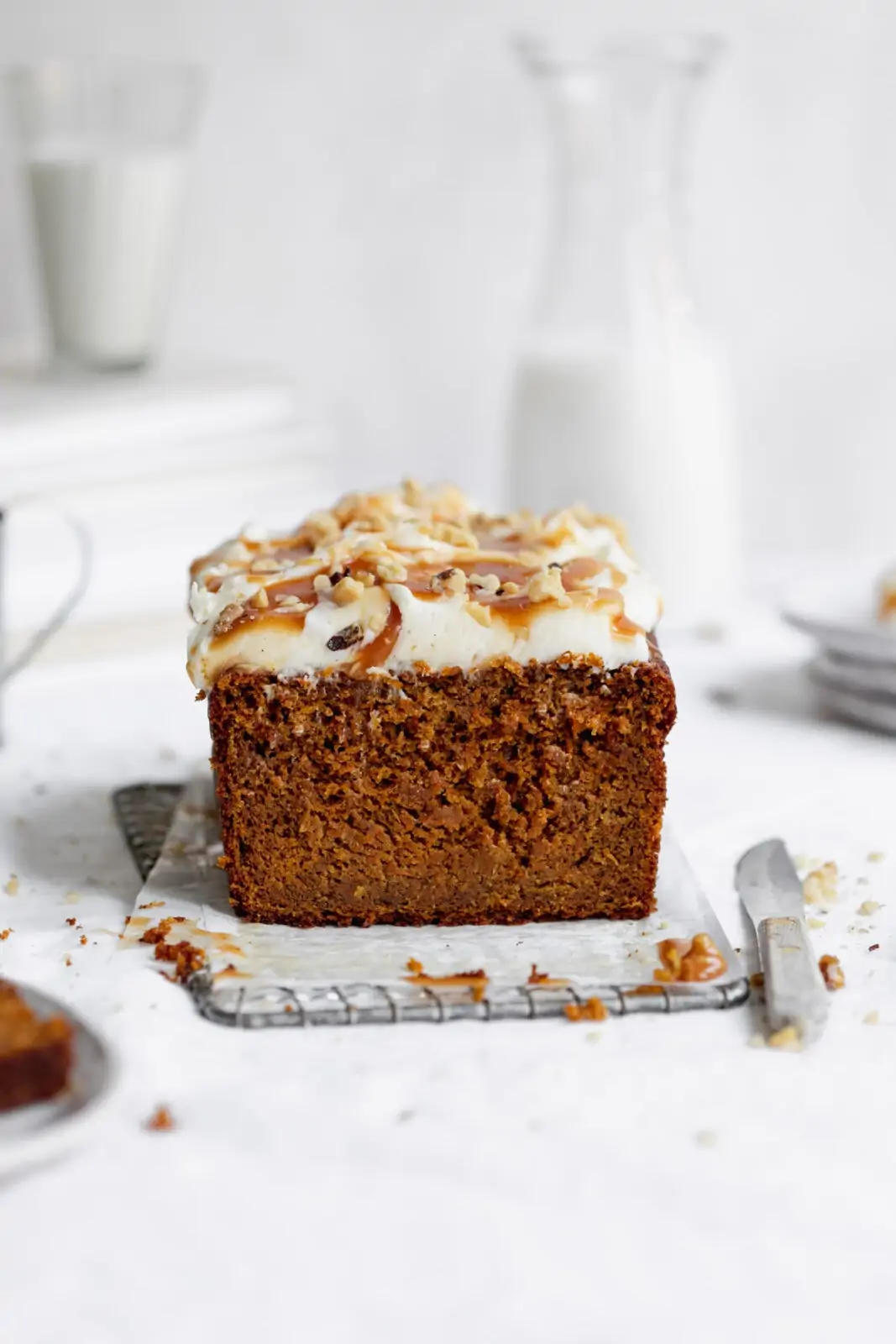 whole wheat carrot cake loaf with cream cheese frosting, caramel and walnuts