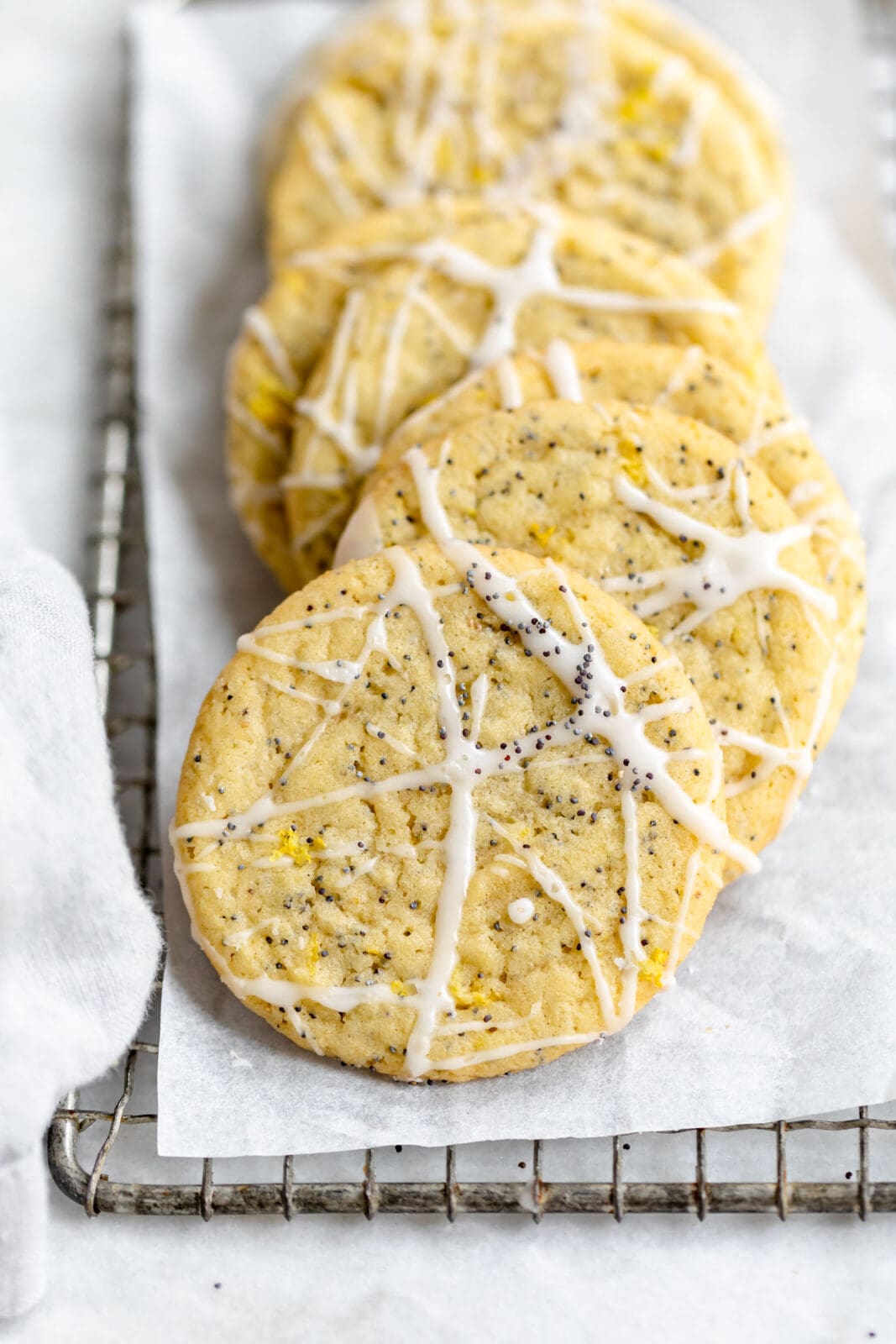 lemon poppy seed cookies with lemon icing and poppy seeds