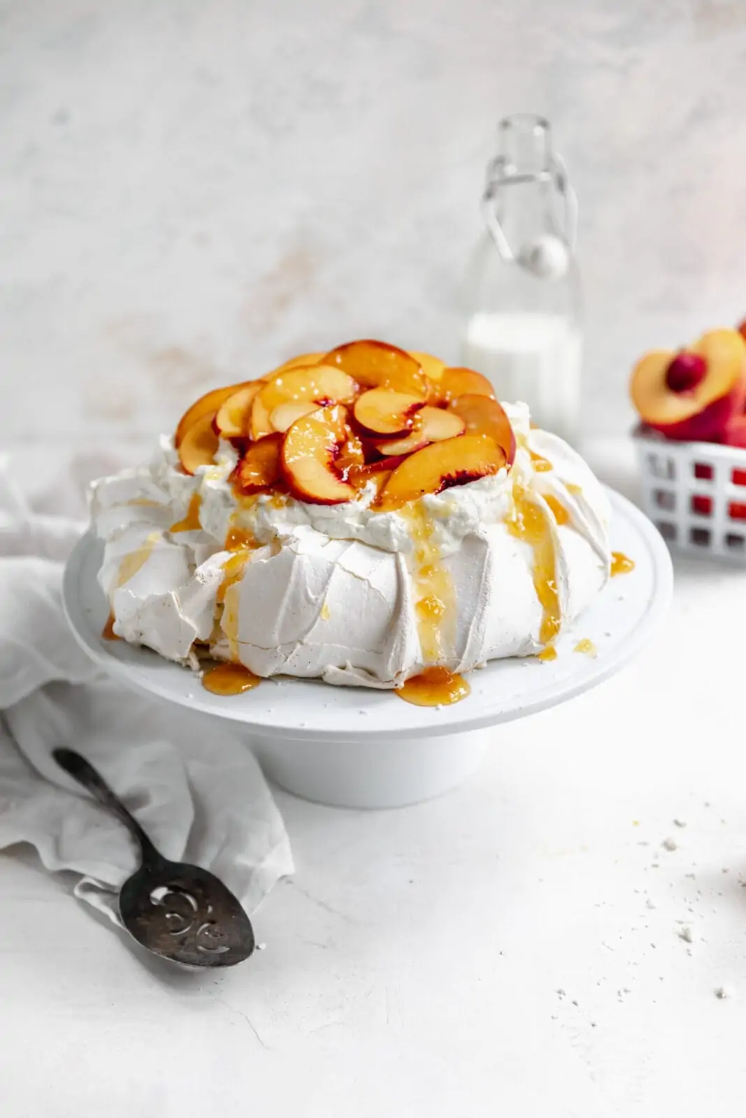 pavlova topped with peaches and vanilla bean whipped cream