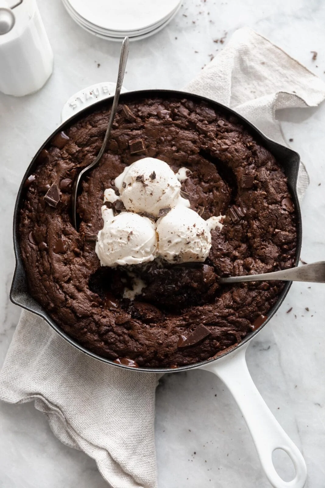 double chocolate giant cookie in a skillet with ice cream
