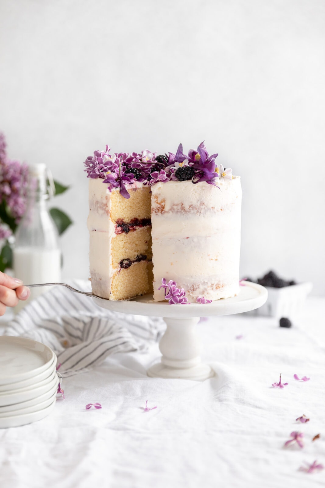 vanilla blackberry cake on a cake stand