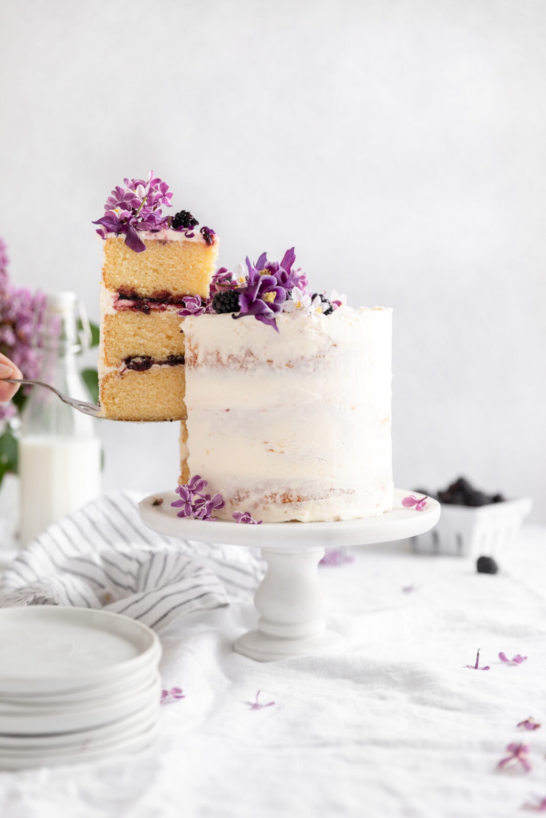 vanilla blackberry cake with a slice out