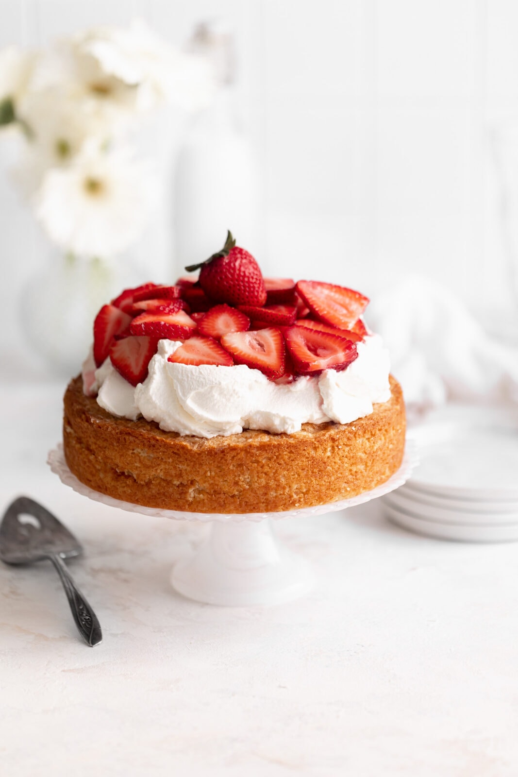 strawberry shortcake cake on a cake stand