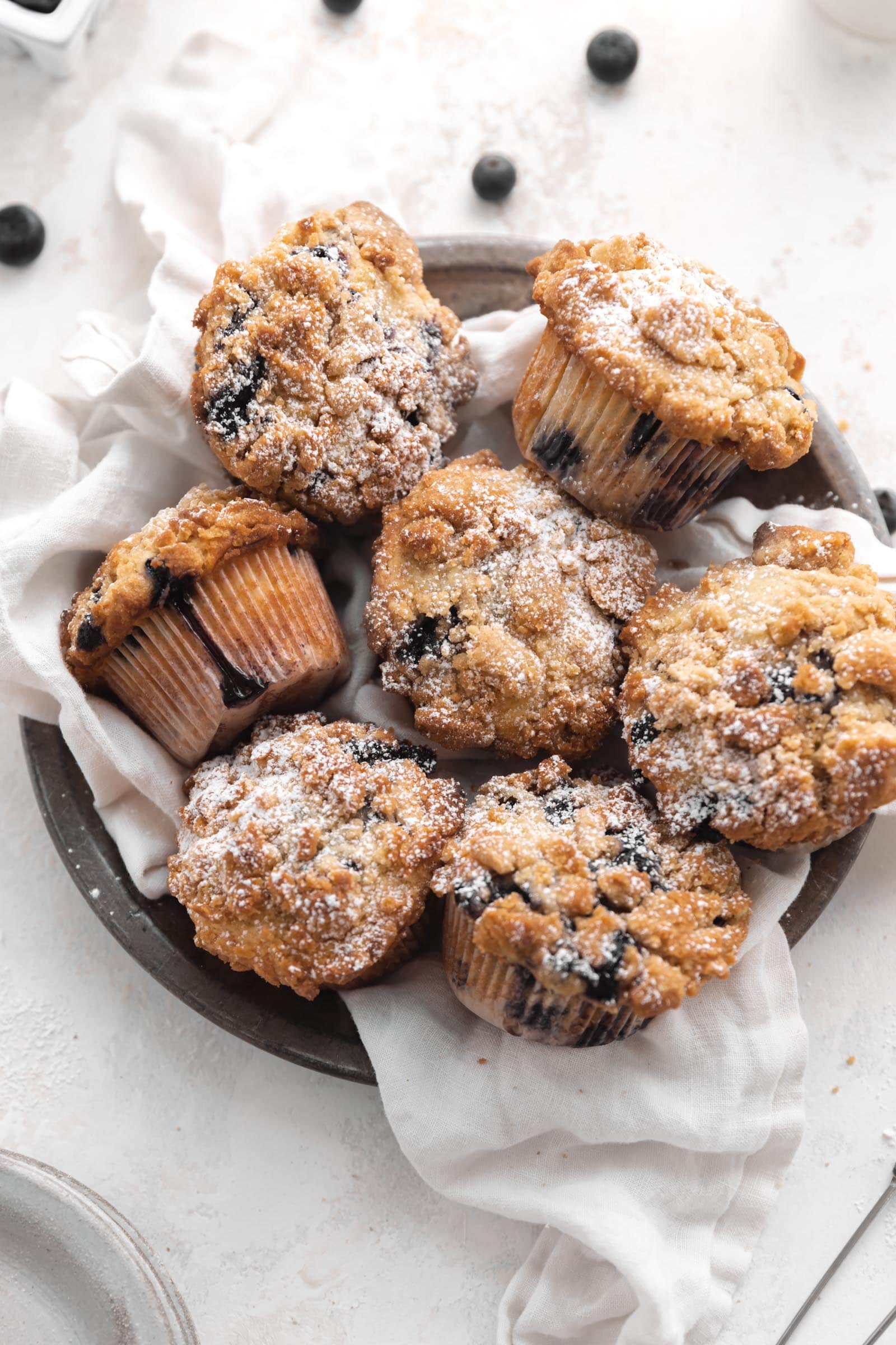 blueberry streusel muffins in a basket