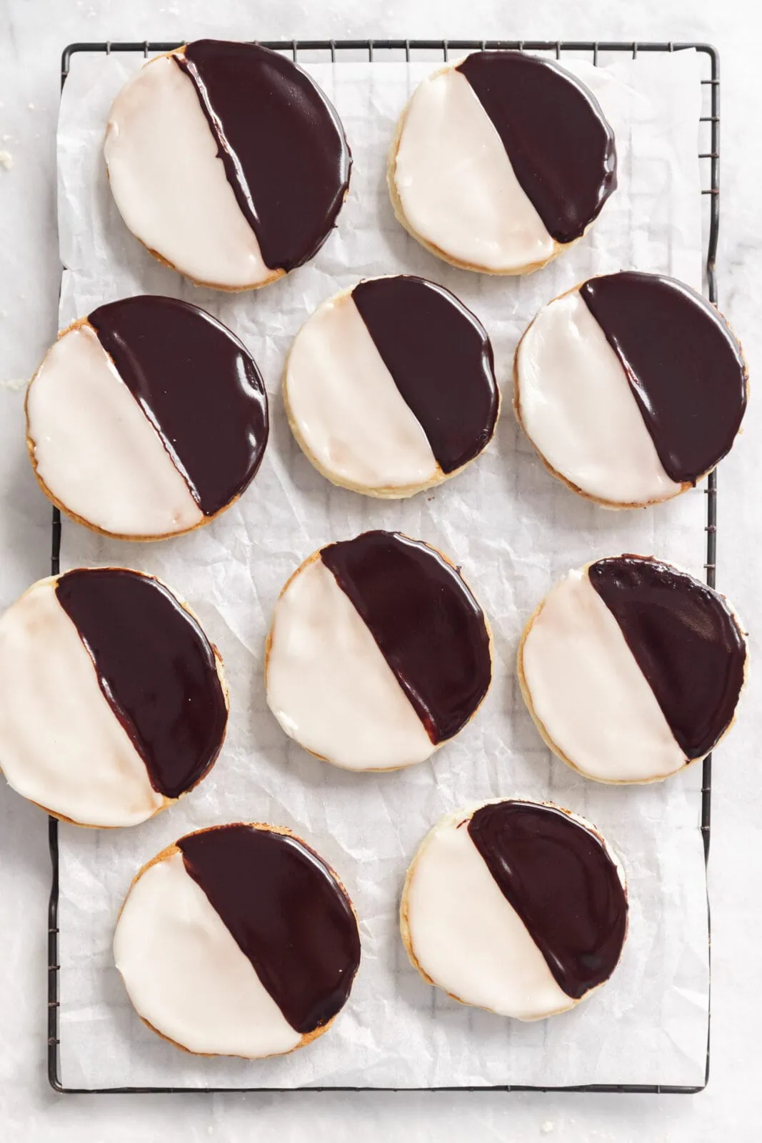 black and white cookies on a cooling rack