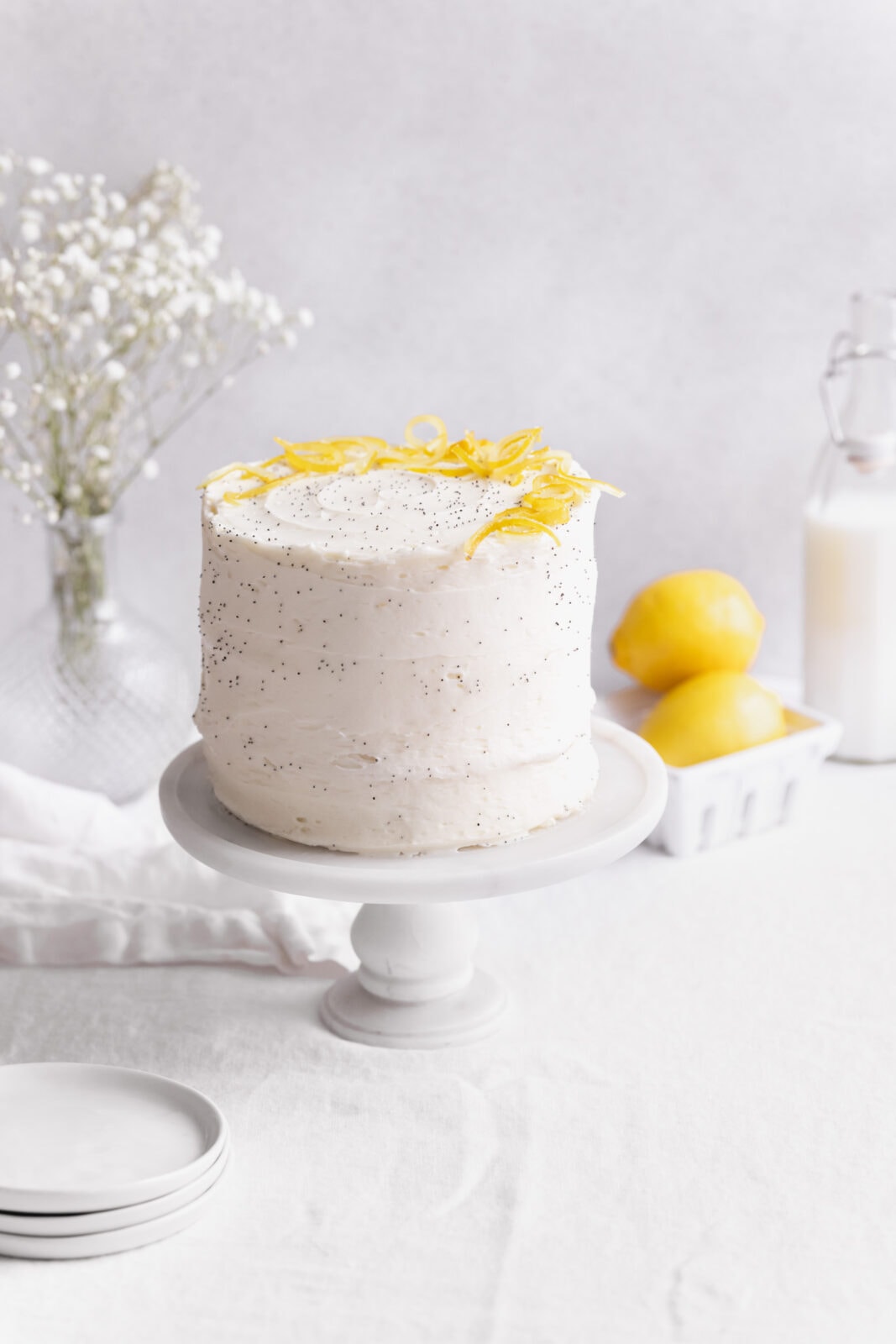 lemon poppy seed cake on a cake stand