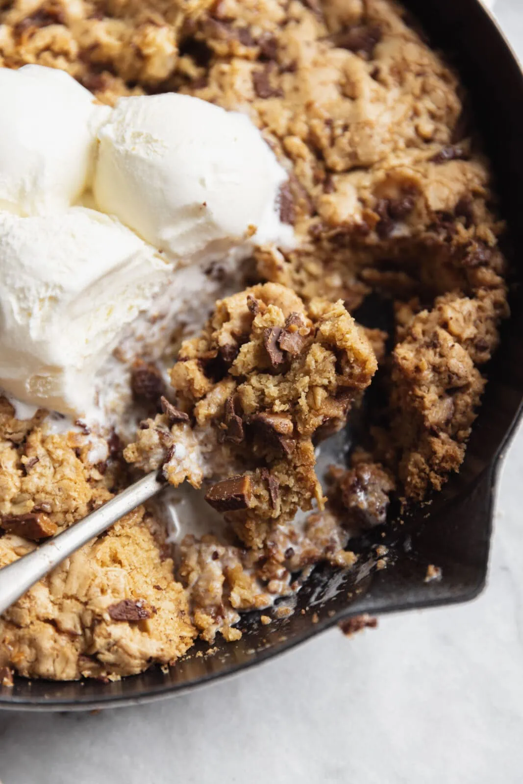 toffee oatmeal chocolate chunk cookie skillet with vanilla ice cream